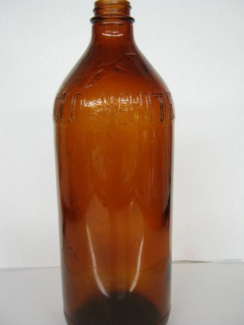 ANTIQUE CLO WHITE BOTTLE AMBER HAS BIRD OVER NAME  