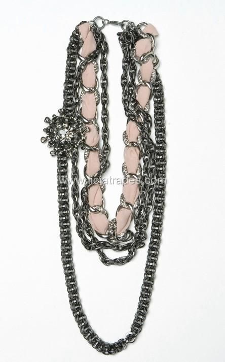 An arty, statement making necklace adds edgy impact to the cleanly 